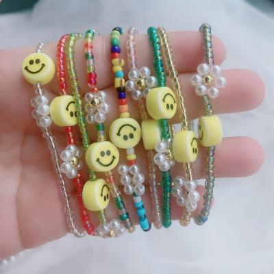 China New Handmade Pure Handmade Elastic Braid Bracelet Bohemian Hawaiian Ethnic Beads Flower Charm Happy Smiley Face Bracelet Women Jewelry for sale