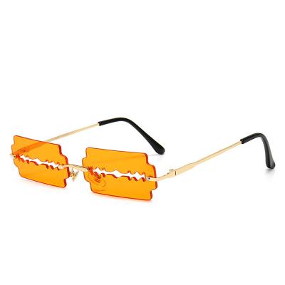 China Fashion sunglasses 2021 funny new fashion colorful strange blade rimless hollow sunglasses for party for sale