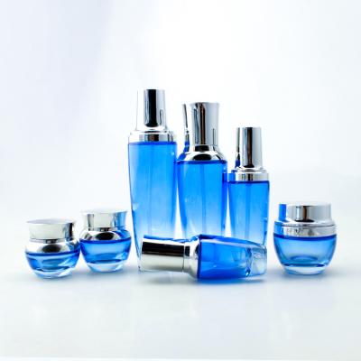 China Cosmetic Cosmetic Bottle Set Cream Glass Jar Glass Bottles Blue Perfume Different Sizes With Gold Silver Top for sale