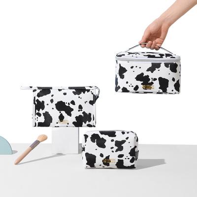 China Fashion Waterproof PU Cow Pattern Travel Storage Bag Handheld Cosmetic Makeup Bag for sale