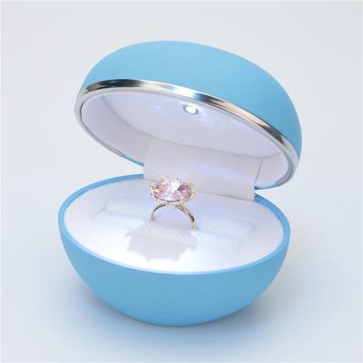 China Elegant custom small blue round plastic proposal engagement ring box with led caja light joyero for sale