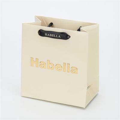 China Custom Logo Jewelry Small Logo Shopping Gift Beige Paper Bag Environmentally Friendly Packaging Bag for sale