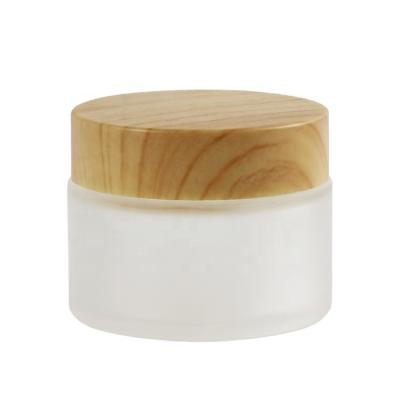 China Hot Sale Reusable 5g 10g 15g 30g 50g Frosted Cosmetic Container Glass Cream Jar With Wooden Cap Makeup Packaging for sale