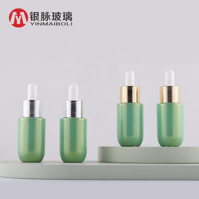 China Personal Care Essential Oil Packaging 15ml Green Pearl Glass Dropper Bottle With Honeycomb Ring Cap for sale