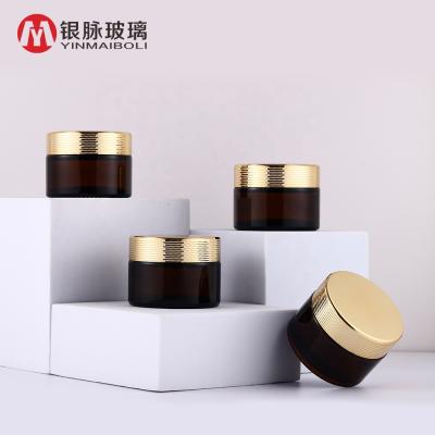 China Personal Care Glass Jar With Gold Honeycomb Ring Cap Custom Printing Amber Glass Jar For Face Cream for sale