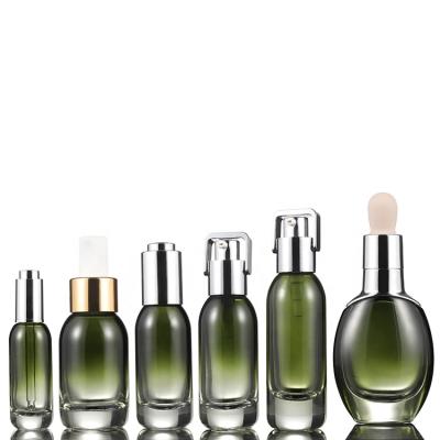 China Personal Care Guangzhou Factory Cosmetic Packaging Luxury Green Glass Bottle Set For Cosmetic Packaging for sale