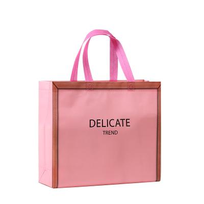 China Luxury Fashion Handled Nonwoven Fabric Orange Laminated Gift Carry Shopping Bags With Custom Printed Logo for sale