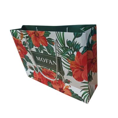 China Recyclable Custom All Over Printing Paper Shopping Bag Fashion Clothes Bag With Rope Handle for sale