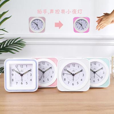 China Small Circular Antique Simple Luminous Brown Clock Wave Motion Style Wave Movement Music Mute Alarm Clock for sale