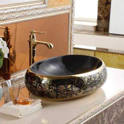 China Antique Oval Lavabo Countertop Banyo Hand Wash Bathroom Cabinet Luxury Black And Gold Plated Ceramic Sink for sale