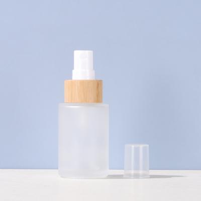 China Highly Demand Cosmetic Bamboo And Wood Cover Spray Frosted Cosmetic Glass Bottles for sale