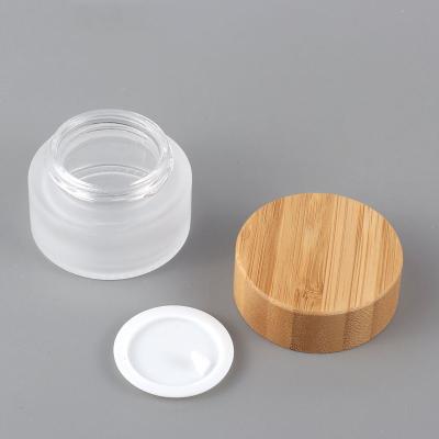 China Bamboo Lid Cosmetic Empty Green Frosted Glass Cream Jar Container For Face Cream Cosmetic Packaging 15ml 30g 50g 100ml for sale