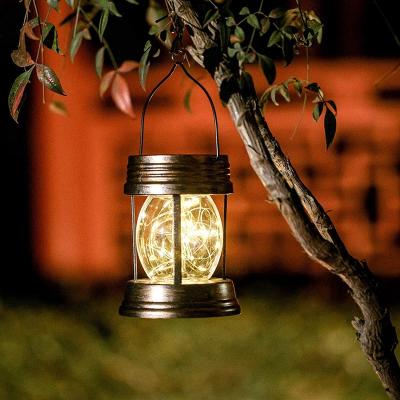 China Retro Solar Powered Garden Lamp Hanging Lanterns Heat Hollow Solar Lights for sale