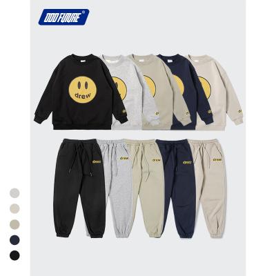 China Smart casual boutique DRAWN print sweatpants set kids hoodie and smile face printed boys and girls suit kids high quality tracksuit for sale