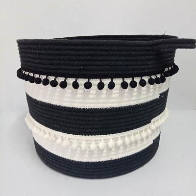 China Sustainable Hot Selling Round Black Woven Cotton Rope Storage Basket With Decorative Tassel for sale