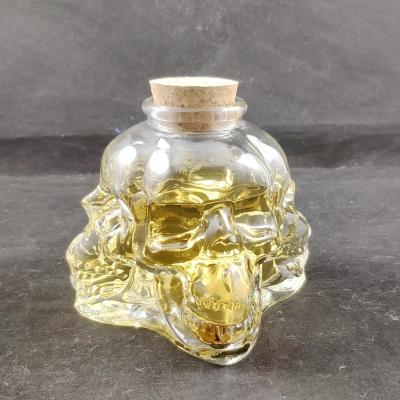 China Beverage factory new release 500ml skull glass bottles glass skull bottle/skull wine bottle with food grade cork for whiskey wine for sale