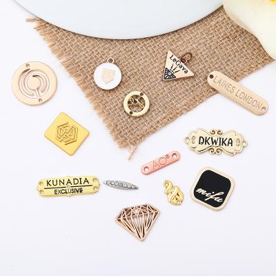 China Viable Sewing Metal Tags Hole Clothing Label Gold Sewing Engraved Logo Dish Name Tag Custom Metal Logo Tag For Clothing for sale