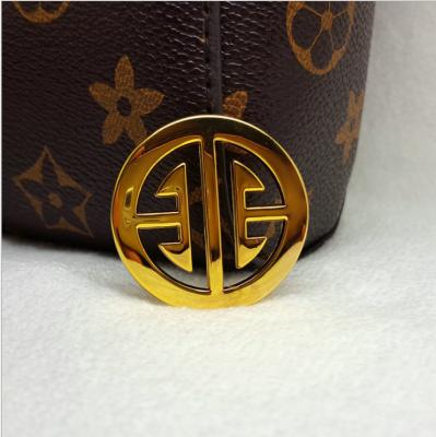 China Washable Metal Label Custom Logo Stamp Small Round Metal Logo Plate For Gloves for sale