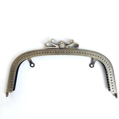 China Wholesale 20.5cm Durable DIY Arch Embossed Bowknot Alloy Handbag Holders Clasps Double Sew In Metal Purse Frame for sale