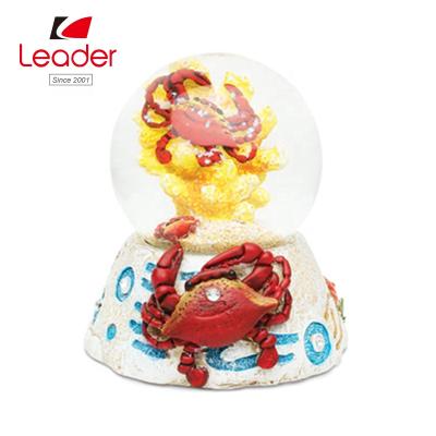 China China Enchanted Custom Resin 65mm Crab Water Ball Snowflake Snow Globe Snow Globe Manufacturers for sale