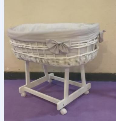 China UK Standard Baby Solid Wood White Wicker Basket Drape Cradle With Castor for sale