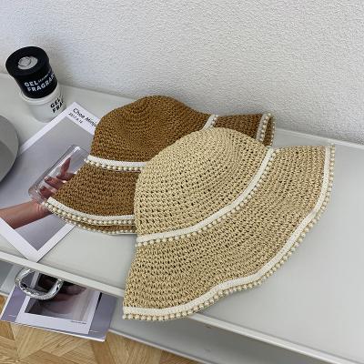 China Outlet Elements Girls Fashionable Double-Layer Straw Hat Large Popular Fresh Hollow White Pearl Embellished Wide Brim Women Beach Hat for sale