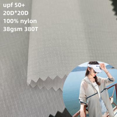 China 20D*20D 0.25cm Bottom Waterproof Nylon Elastic Ripstop Fabric 100% Upf 50 Ply Nylon Fabric For Sun Protection Clothing for sale