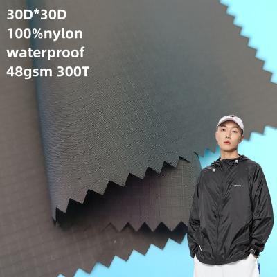 China Waterproof matte full ripstop taffeta fabric 100% full ripstop nylon ripstop fabric 30D*30D 0.27cm nylon ripstop fabric for sale