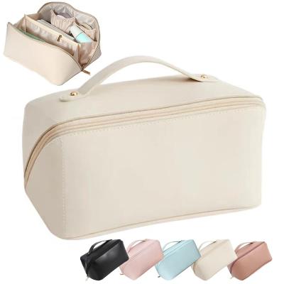 China Large Capacity Cosmetic Multi-Function Leather Travel Bag PU Fashion Makeup Handle and Divider Travel Storage Bag for sale