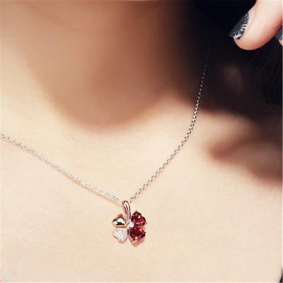 China Rose Gold Plated Two Tone eye-catching Lucky Clover Pendant Exquisite Red Crystal Necklace Pendant for women fashion jewelry accessories for sale