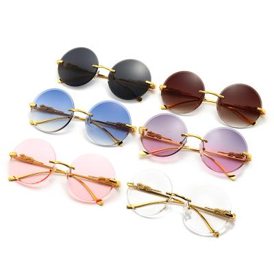 China Frameless cut edge sunglasses street retro frame ladies sunglasses fashion round exquisite decoration personality round shot concave shape sunglasses for sale