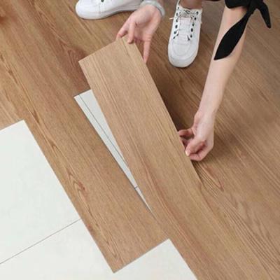 China Modern Household Indoor Waterproof Self Adhesive UV Coating Lay Embossed Wood Planks Click Gray Luxury LVT Vinyl Flooring for sale