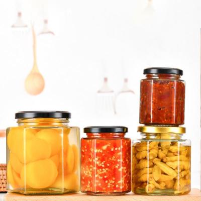 China Food Glass Storage Honey Jar Empty Hexagonal Honey Pot Bottle Food Storage Packaging Jars Thicken Hexagon Jam Jar for sale