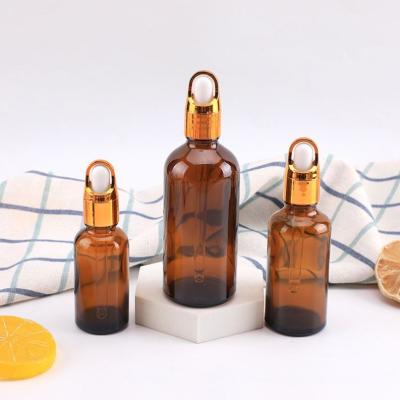 China Cosmetic Amber frosted clear essential oil flat shoulder serums glass dropper bottle with aluminum lid for sale