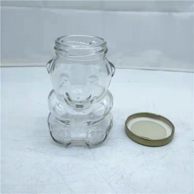 China 9 oz Bear Honey Jar Food Storage Glass Jar Animals Glass Candy Jar Canned Food With Gold Lid For Storage for sale