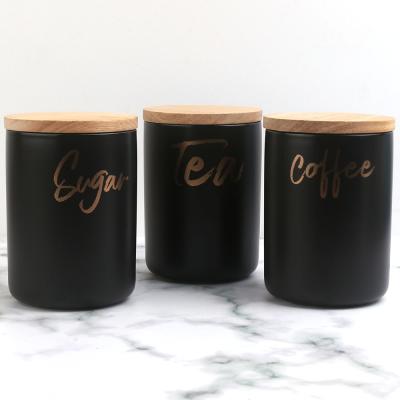 China Wholesale Matte Black Ceramic Tea Coffee Sugar Gold Canister Jar With Lid Wooden Tableware Set for sale