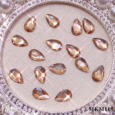 China Champagne Nail Art Crystal For Finger Nail Art Wholesale K9 Quality Gold Bottom And Fake Nail Stone for sale