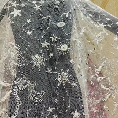 China Viable Sequin Pegasus Sky Beaded Starry Pattern Mesh Embroidery Lace Fabric Wedding Dress Embroidered Fabric for sale