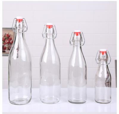 China Beverage Clear 500ml 750ml Bordeaux Flat Bottom Swing Top Lid Beverage Beer Glass Wine Bottle With Caps for sale