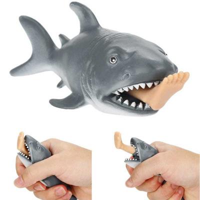 China Hot Creative Plastic Plush Anti Stress Compression Toys Hungry Shark With Noise Surfer Leg Stress Relief Funny Spoof Toy Trick Gift for sale