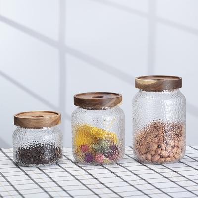 China Freshness Preservation Kitchen Storage 350ml 500ml 700ml Hammered Glass Jar With Acacia Wood Lid for sale