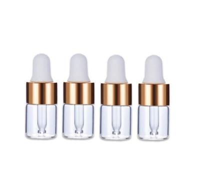 China Recyclable Essential Oil Glass Dropper Bottles 1Ml 2Ml 3Ml 5Ml Mini Clear Cosmetic Perfume Sample Dropper Vials With Gold Cap for sale