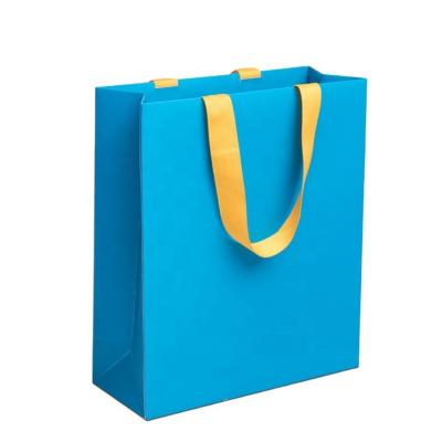 China Custom Classic Gold Stamping Logo Printed Blue Kraft Paper Printing Bag Gift Shopping Paper Bags for sale