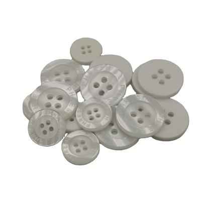 China Customized Washable 4 Holes Brand Buttons White Plastic Pearl Button for sale