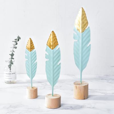 China Nordic minimalist iron feather design decoration for small office desk wooden base metal ornaments for sale