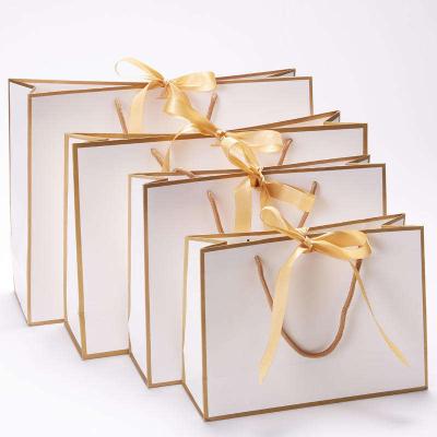 China Recyclable Cheap white luxury packaging paper bags gold logo custom printed art paper bag gold ribbon handles luxury shopping paper bag for sale