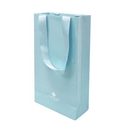 China Recyclable Blue Cardboard Jewelry Gift Shopping Bag Luxury Cosmetic Elegant Ribbon Gift Ribbon Paper Bags With Logo Printing for sale