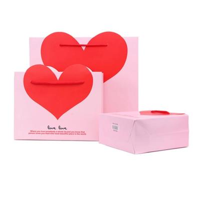 China Cheap Wholesale Wedding Gift Paper Bag Of Recyclable 3d Lamination Matte Pink And Red Heart for sale