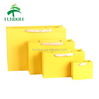 China Small Quantity Recyclable Hot Acceptable Yellow Color Printed Clothing Wholesale Retail Shopping Paper Bag for sale