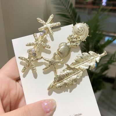 China Seaside hairpin conch starfish shell starfish shell wind retro super fairy soft hits holiday modern minimalist French mute gold wind clip. for sale